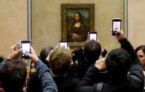 file-photo-visitors-take-pictures-of-the-painting-mona-lisa-by-leonardo-da-vinci-at-the-louvre-museum-in-paris